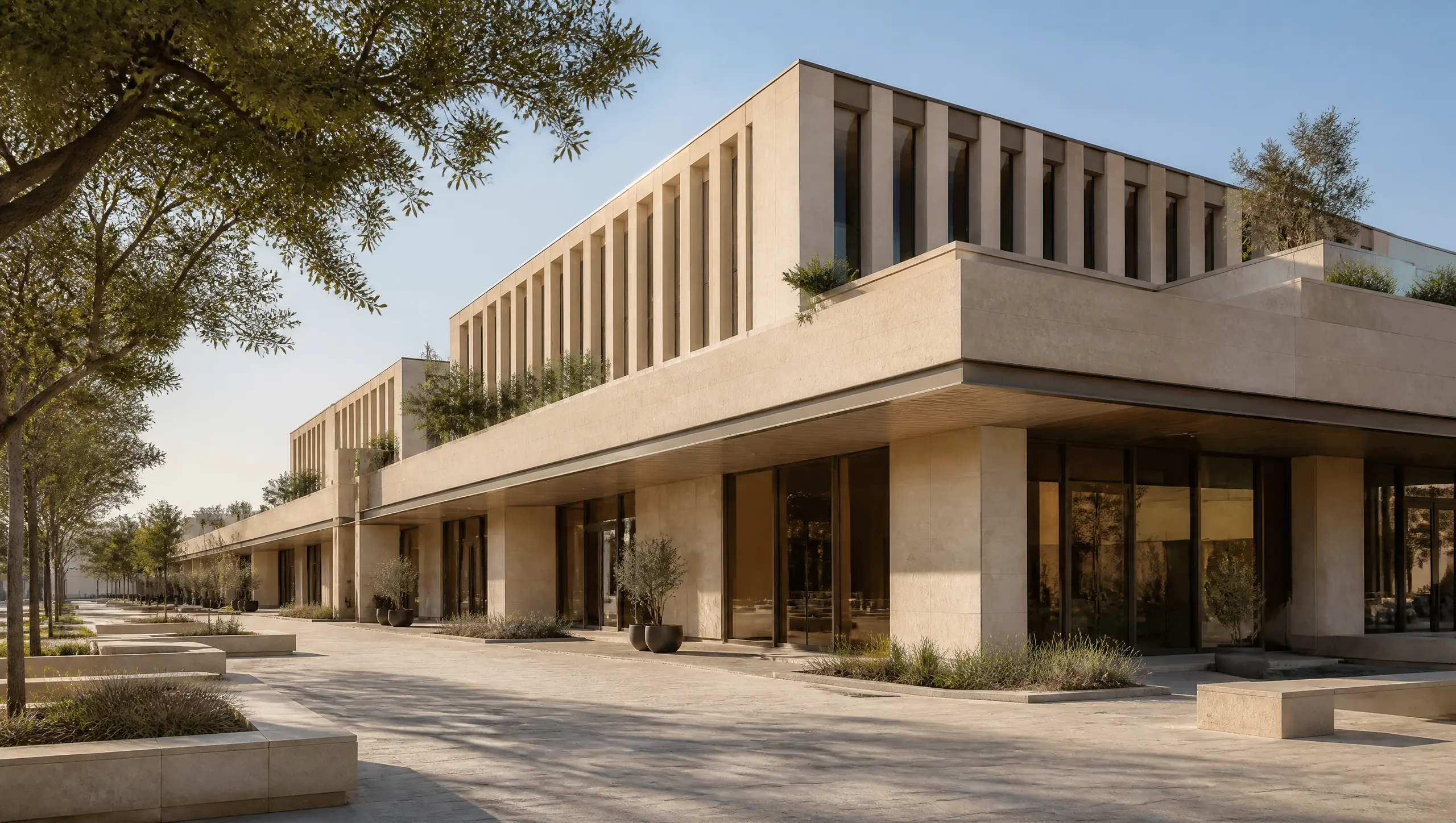 A mixed-use commercial complex with a stone podium, vertical fins and a shaded plaza
