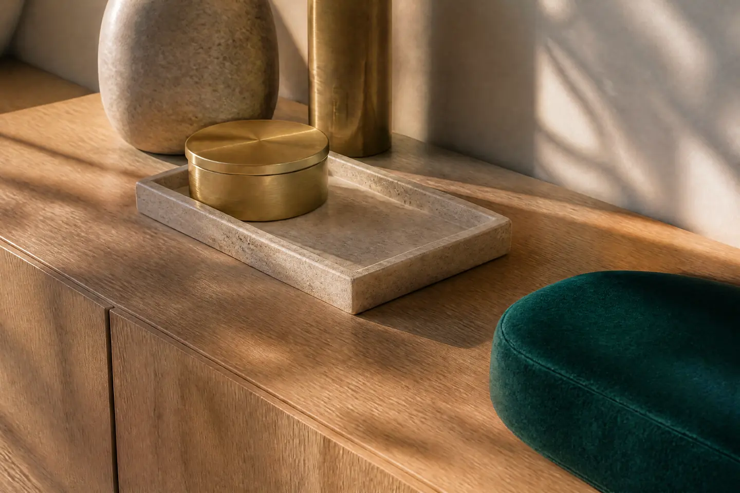 A close-up 3D render of materials: oak, travertine, brass and velvet